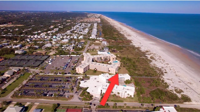 bird's eye view featuring a view of the beach and a water view