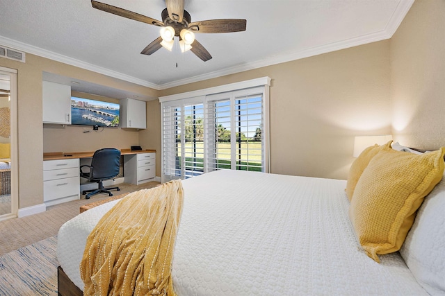 bedroom with light carpet, ceiling fan, access to exterior, built in desk, and ornamental molding