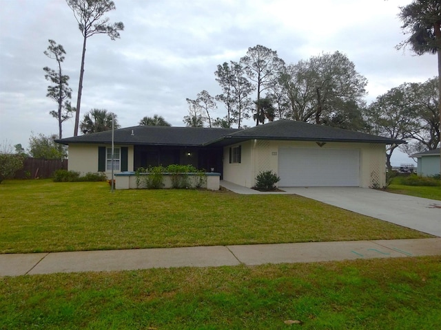 single story home featuring a garage, driveway, a front lawn, and stucco siding