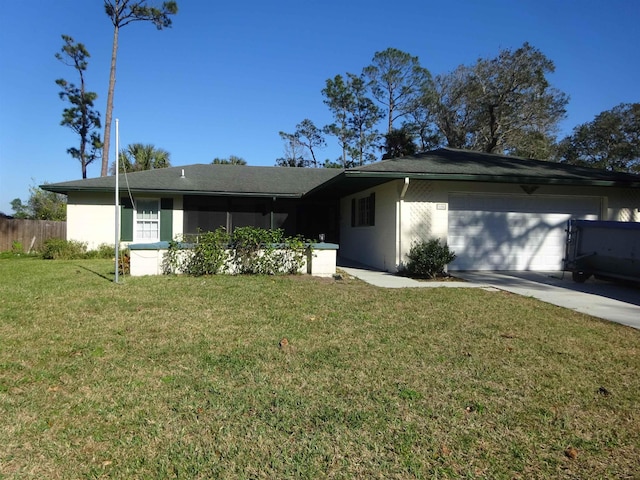 ranch-style home featuring a garage, driveway, a front yard, and fence