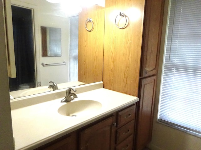 bathroom featuring vanity and toilet