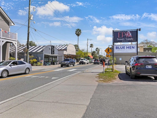 view of road with traffic signs, curbs, and sidewalks