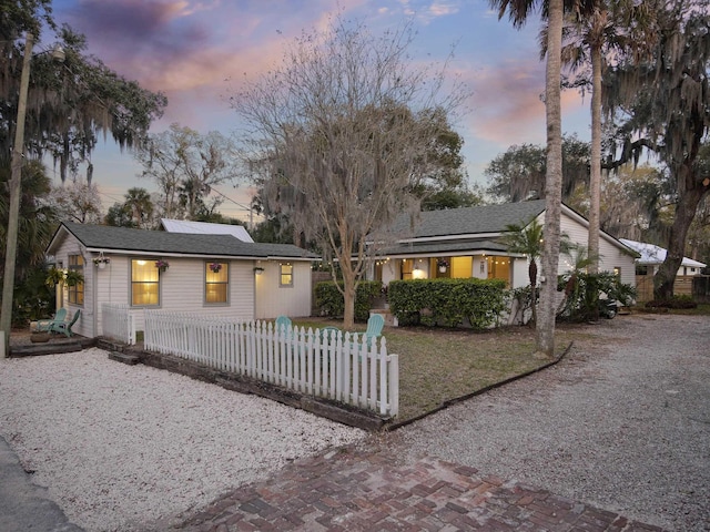 ranch-style home with a fenced front yard