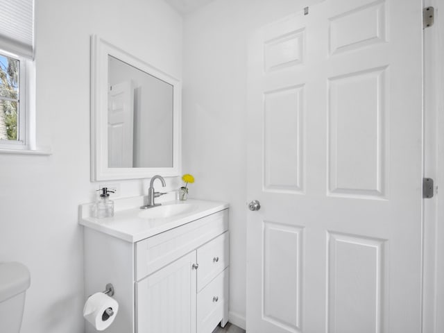 bathroom featuring toilet and vanity