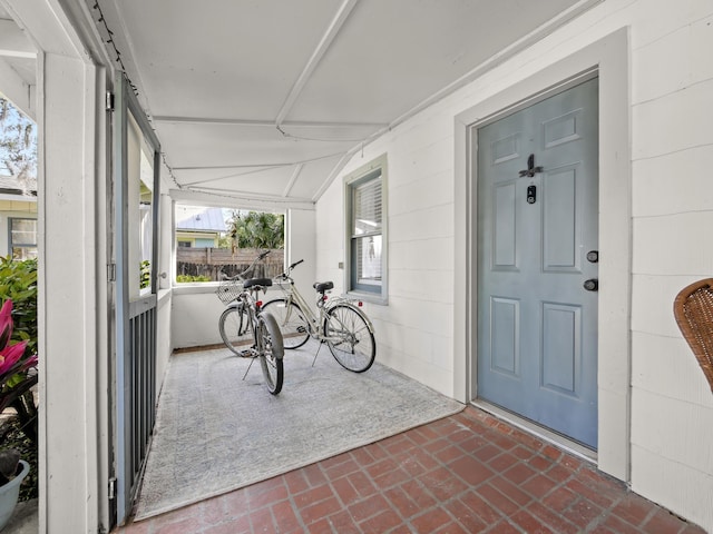 view of exterior entry featuring a porch