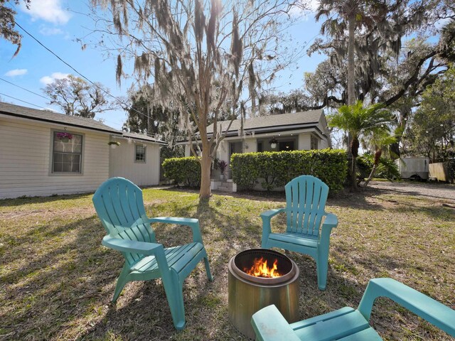 view of yard featuring an outdoor fire pit