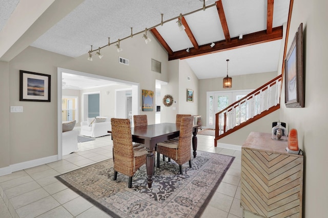 6 Versaggi Pl, Saint Augustine, FL 32080 - dining space with light tile patterned floors, stairway, high vaulted ceiling, a textured ceiling, and beamed ceiling