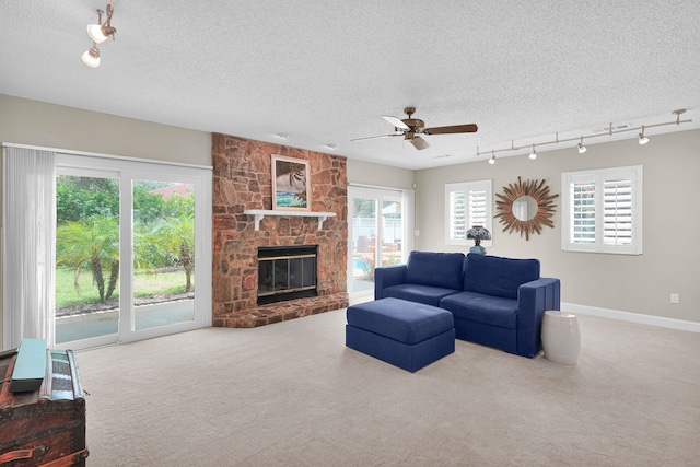 6 Versaggi Pl, Saint Augustine, FL 32080 - carpeted living room with track lighting, ceiling fan, a textured ceiling, and healthy amount of natural light