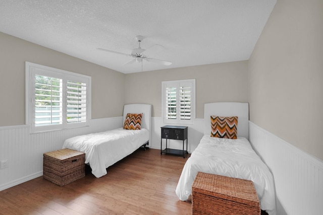 6 Versaggi Pl, Saint Augustine, FL 32080 - bedroom featuring a wainscoted wall, wood finished floors, ceiling fan, and a textured ceiling