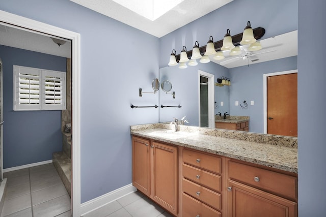 6 Versaggi Pl, Saint Augustine, FL 32080 - full bath featuring a skylight, vanity, tile patterned flooring, and a walk in shower