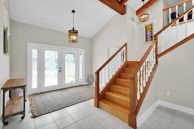 6 Versaggi Pl, Saint Augustine, FL 32080 - tiled entrance foyer with a chandelier, stairway, high vaulted ceiling, french doors, and beam ceiling