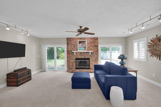 6 Versaggi Pl, Saint Augustine, FL 32080 - carpeted living area with track lighting, a ceiling fan, a textured ceiling, and a fireplace