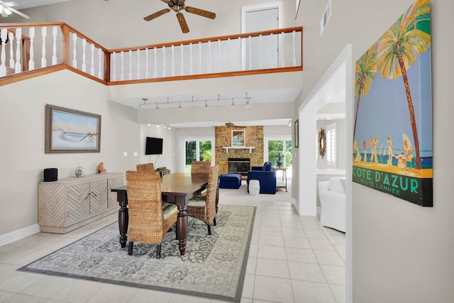 6 Versaggi Pl, Saint Augustine, FL 32080 - dining room featuring a ceiling fan, a stone fireplace, tile patterned flooring, and a high ceiling