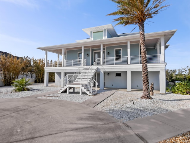 raised beach house featuring a porch