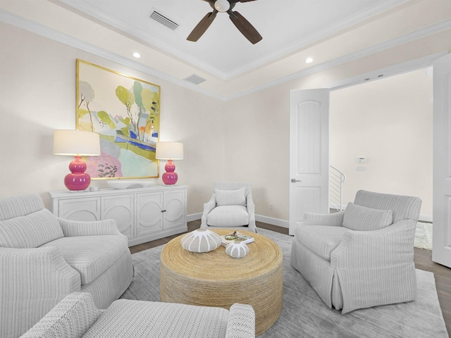 living room with ceiling fan, wood-type flooring, and ornamental molding