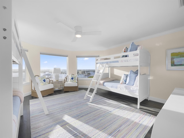 bedroom featuring hardwood / wood-style flooring, ceiling fan, and crown molding