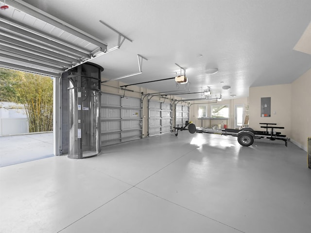 garage with electric panel and a garage door opener