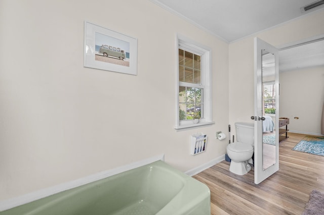 18 Ocean Ave, Saint Augustine, FL 32084 - bathroom featuring plenty of natural light, wood finished floors, ornamental molding, a bathtub, and heating unit