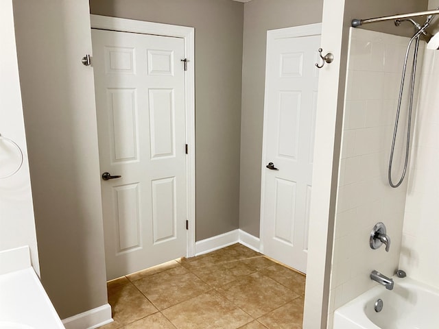 bathroom featuring tile patterned flooring and shower / bath combination