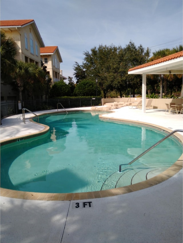 view of swimming pool with a patio