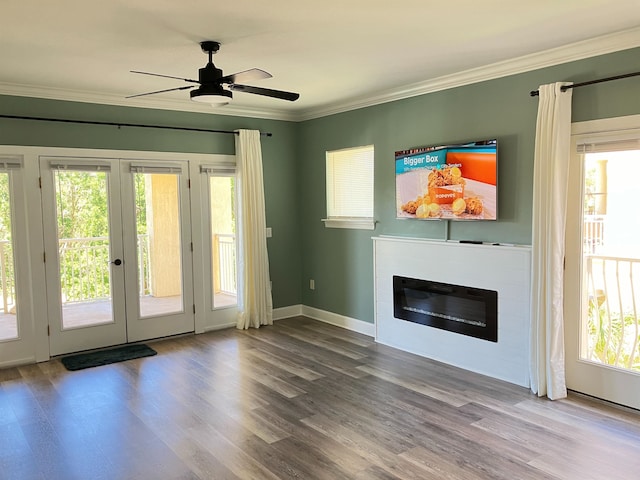 unfurnished living room featuring crown molding, plenty of natural light, ceiling fan, and hardwood / wood-style floors