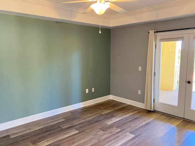 empty room featuring hardwood / wood-style flooring, ceiling fan, crown molding, and french doors