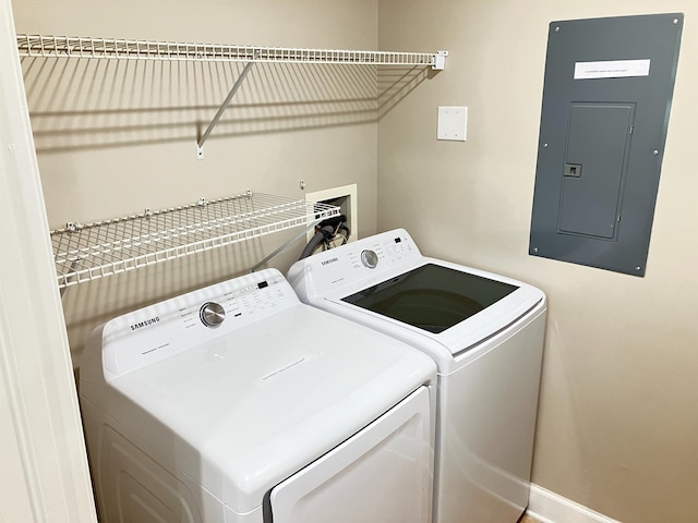 laundry area with separate washer and dryer and electric panel