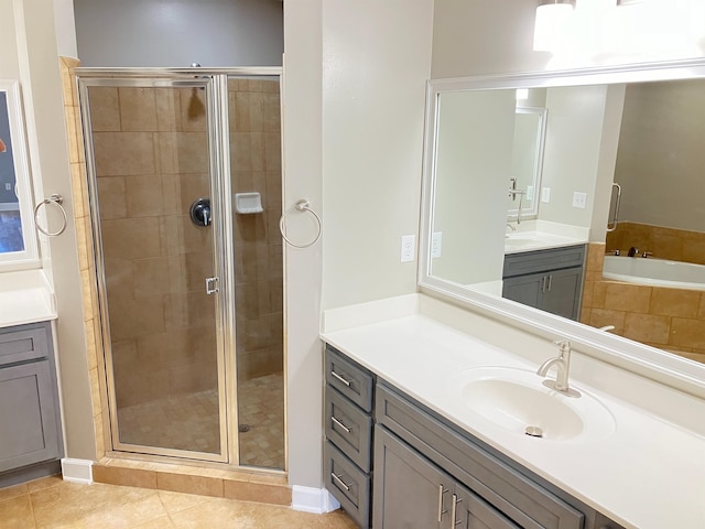 bathroom with plus walk in shower, vanity, and tile patterned floors