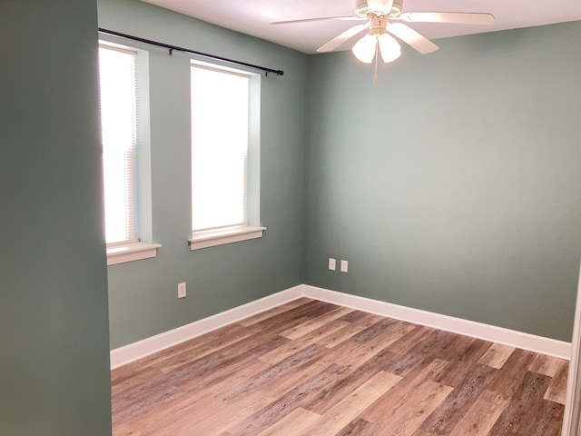 spare room featuring wood-type flooring and ceiling fan