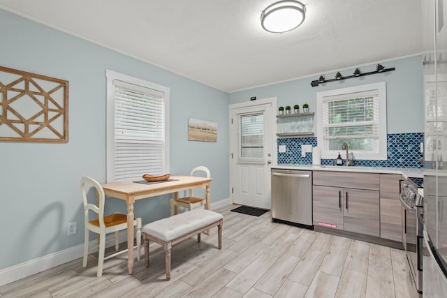 kitchen with stainless steel appliances, light hardwood / wood-style flooring, tasteful backsplash, and sink