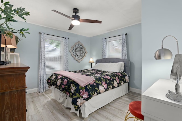 bedroom with light hardwood / wood-style floors and ceiling fan