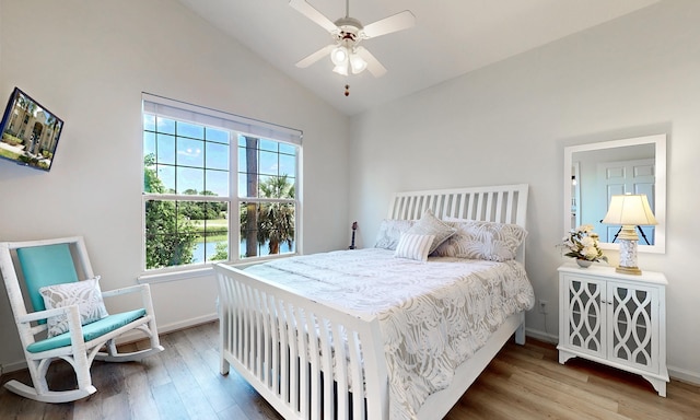 705 Augusta Cir, Saint Augustine, FL 32086 - bedroom featuring wood finished floors, baseboards, high vaulted ceiling, a ceiling fan, and a water view