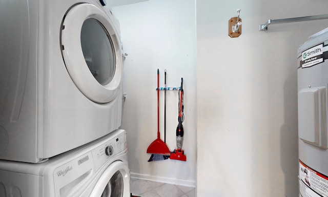 705 Augusta Cir, Saint Augustine, FL 32086 - laundry area with stacked washer / drying machine, tile patterned floors, baseboards, and electric water heater