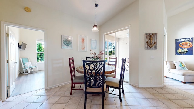 705 Augusta Cir, Saint Augustine, FL 32086 - dining area with lofted ceiling, light tile patterned floors, baseboards, and ceiling fan