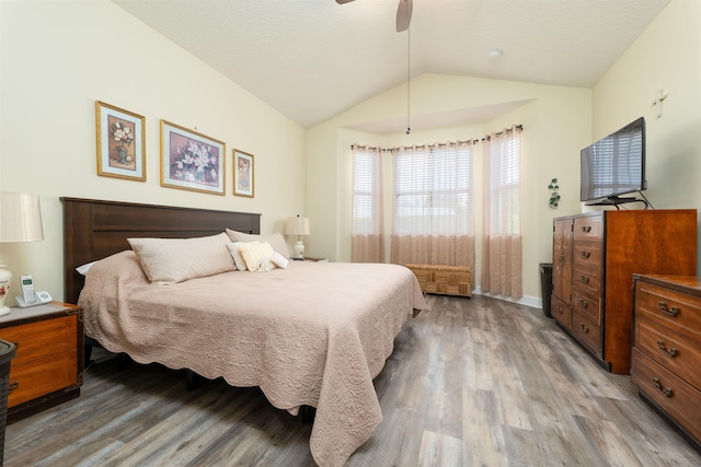 bedroom featuring wood-type flooring, ceiling fan, and lofted ceiling