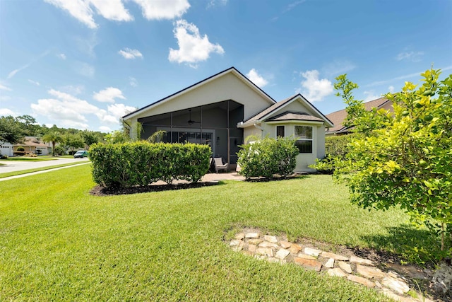 view of front of house with a sunroom and a front lawn