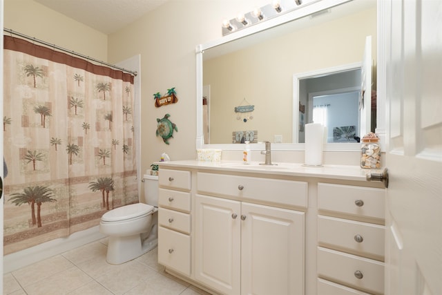 bathroom featuring tile patterned flooring, vanity, curtained shower, and toilet