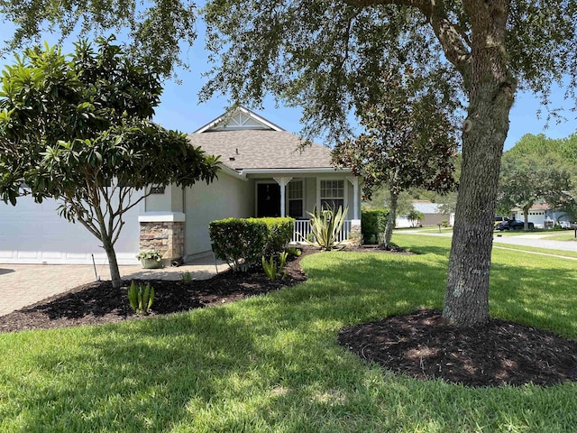 view of front facade featuring covered porch, a front yard, and a garage