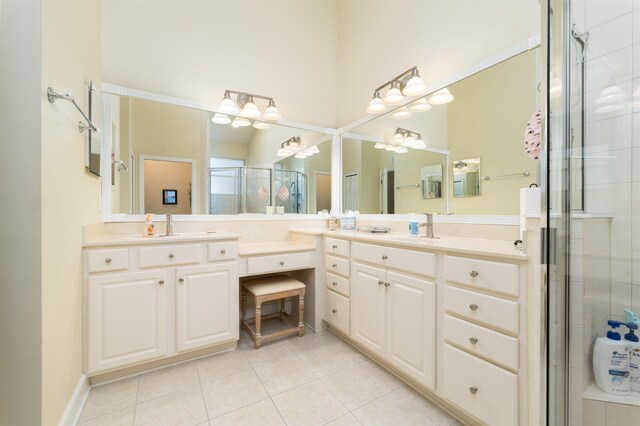 bathroom featuring vanity, tile patterned floors, and walk in shower