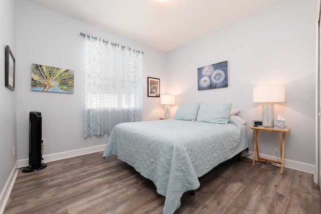 bedroom with dark hardwood / wood-style flooring