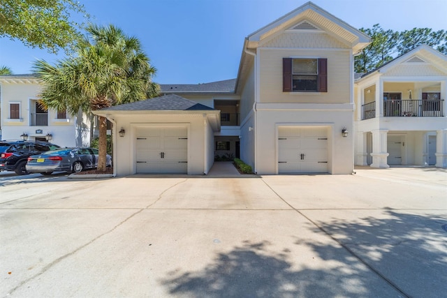 117 Laurel Wood Way Unit 105, Saint Augustine, FL 32086 - view of front of house featuring driveway, stucco siding, roof with shingles, and an attached garage