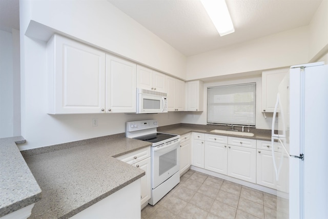 117 Laurel Wood Way Unit 105, Saint Augustine, FL 32086 - kitchen featuring white appliances, a sink, white cabinets, and light tile patterned floors