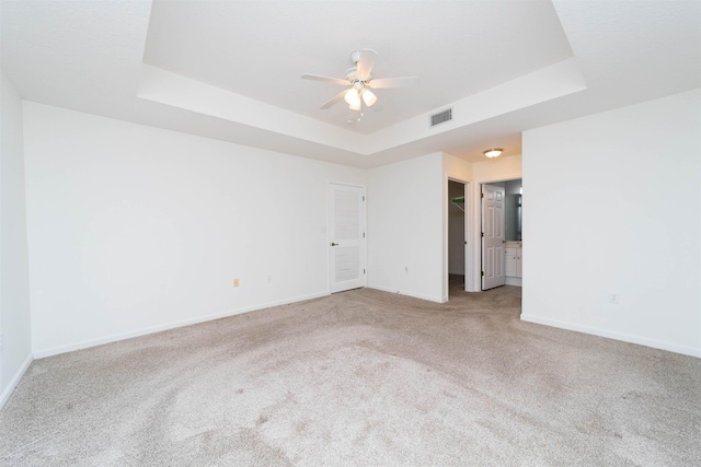 117 Laurel Wood Way Unit 105, Saint Augustine, FL 32086 - spare room featuring a raised ceiling, carpet floors, baseboards, and ceiling fan