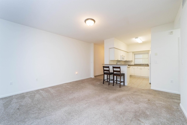 117 Laurel Wood Way Unit 105, Saint Augustine, FL 32086 - living room with light colored carpet and baseboards