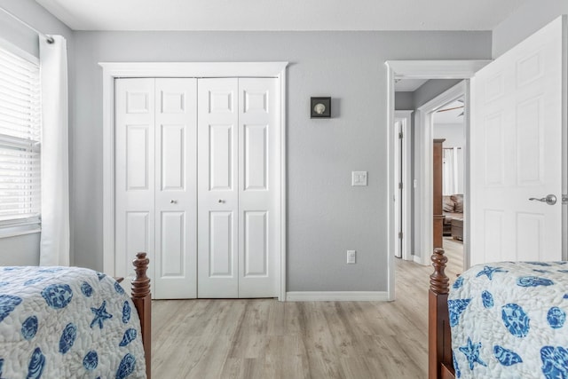 bedroom with a closet and light hardwood / wood-style floors