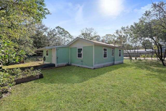 view of side of home featuring a lawn