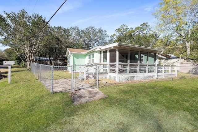 view of side of home with a yard and a sunroom