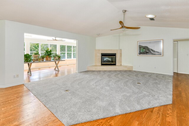 1536 San Rafael Way, Saint Augustine, FL 32080 - unfurnished living room featuring a ceiling fan, lofted ceiling, a tiled fireplace, baseboards, and wood finished floors