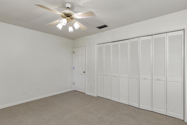 1536 San Rafael Way, Saint Augustine, FL 32080 - unfurnished bedroom with light carpet, baseboards, a textured ceiling, a closet, and a ceiling fan