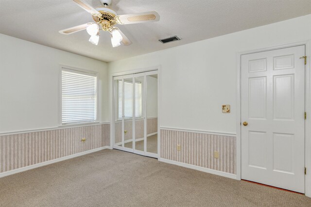 1536 San Rafael Way, Saint Augustine, FL 32080 - carpeted empty room featuring a ceiling fan, wainscoting, and a textured ceiling